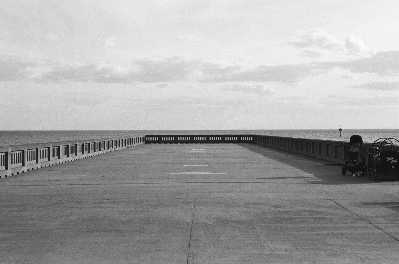 Analog photograph, swimmers near a rocky pier